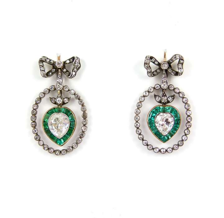 Pair of diamond and emerald heart cluster pendant earrings from diamond ribbon bow tops